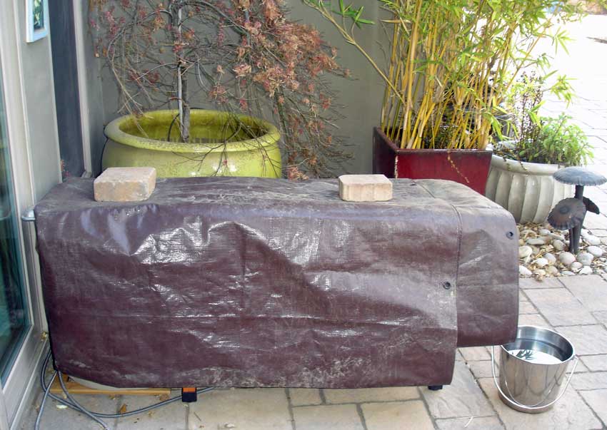 Outdoor cat houses covered by a tarp