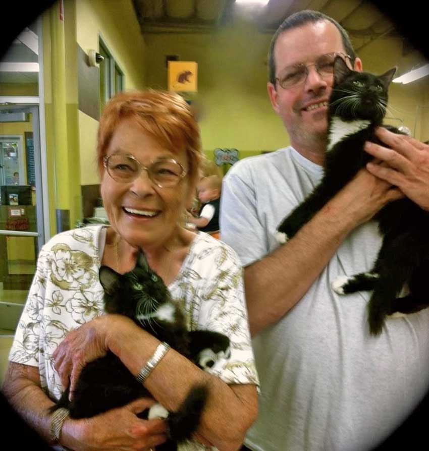 Franny Syufy and son carrying two tuxedo cats Oct 2013.