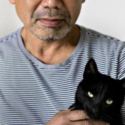 Asian guy with black cat