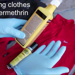 Spraying clothes with permethrin