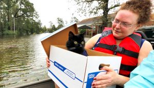 Carla Ramm checks on her cat Jackjack after they were loaded onto a boat during their rescue from rising flood waters in the aftermath of Hurricane Florence, in Leland, North Carolina