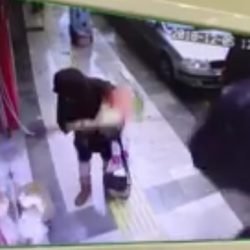 Turkish woman in Turkey strikes stray cat with cloth