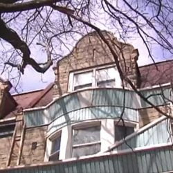The top floors of the house from the outside. This is a large house.