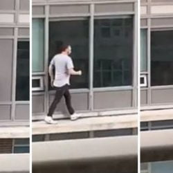 Man traverses outside of building to get his cat