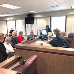 Nancy Segula, second from left, appears in front of Garfield Heights Municipal Court Judge Jennifer Weiler with her attorney, the city's dog warder, and the city's law director.