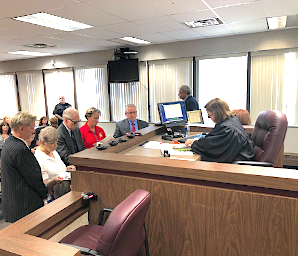 Nancy Segula, second from left, appears in front of Garfield Heights Municipal Court Judge Jennifer Weiler with her attorney, the city's dog warder, and the city's law director.