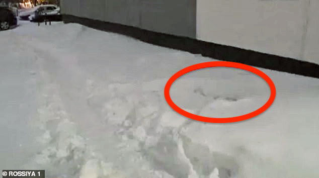 The hole in the snow where the girl impacted the ground
