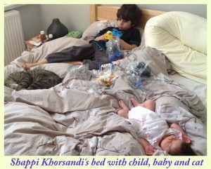 Shappi Khorsandi's large bed with cat, baby and child