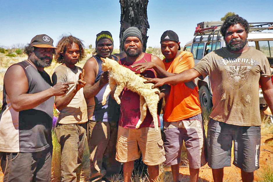 Aboriginal Australians with the feral cat they killed