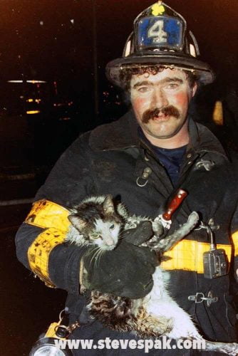 Raw photograph of firefighter and cat