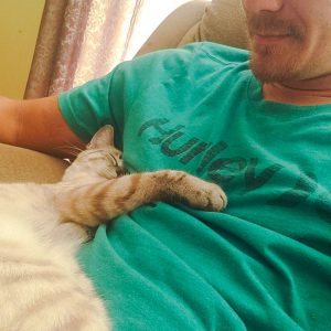 Man with cat snuggling up