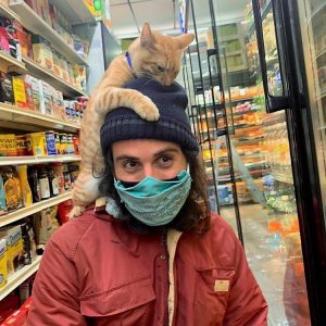 Bodega cat finds a friendly customer to climb on