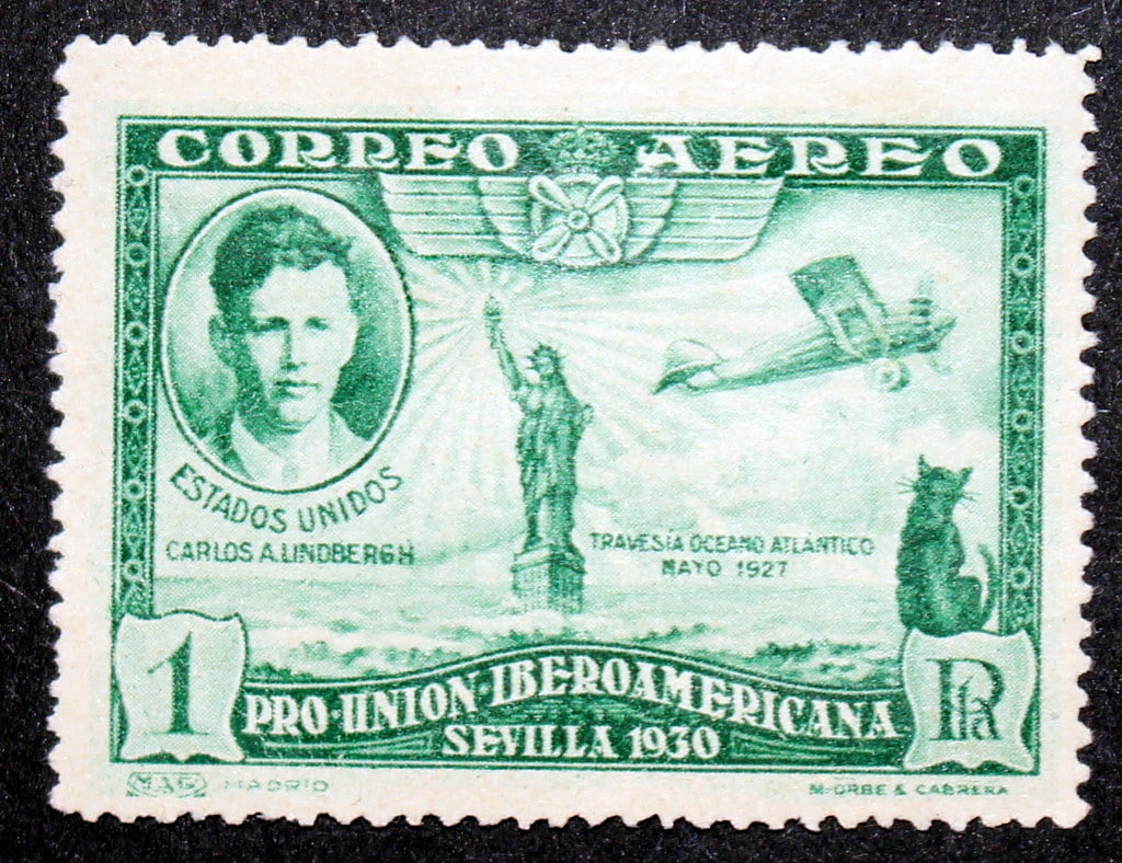 The first stamp to feature a cat issued in 1930 by Spain to commemorate the first non-stop transatlantic flight by Charles Lindberg