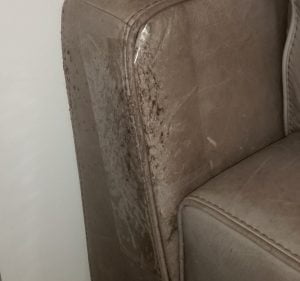 Very old scratched armchair that was protected with wide double-sided tape late in life!
