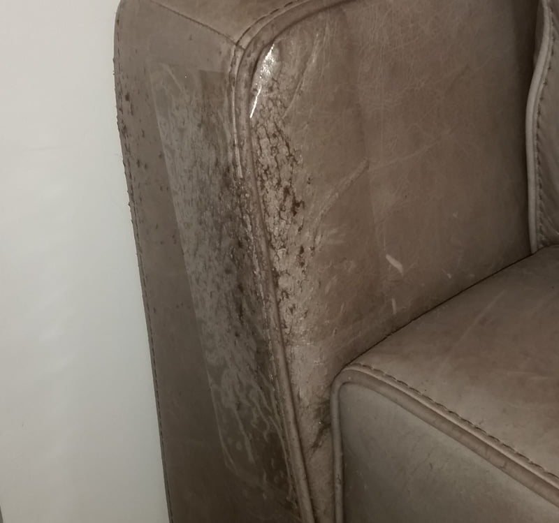 Very old scratched armchair that was protected with wide double-sided tape late in life!