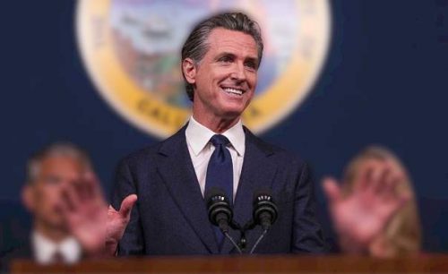 Gov of California Gavin Newsom signs a bill into law protecting cats and dogs from animal testing in the state