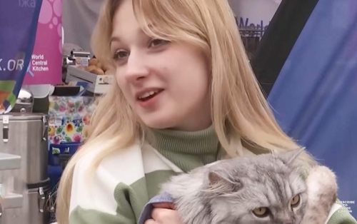 Young woman refugee from Ukraine and her cat - her 'son'.